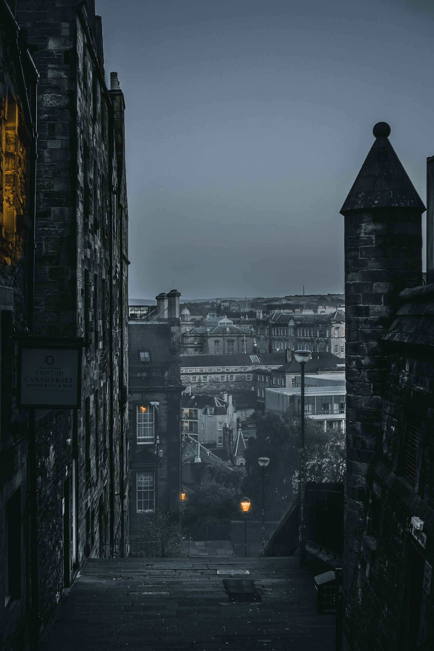 A stone stairway descending through Edinburgh’s Old Town at dusk